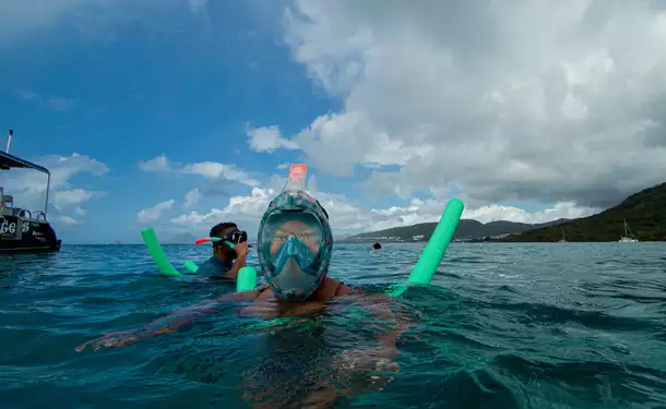 Webbed snorkeling by boat (on the corals)